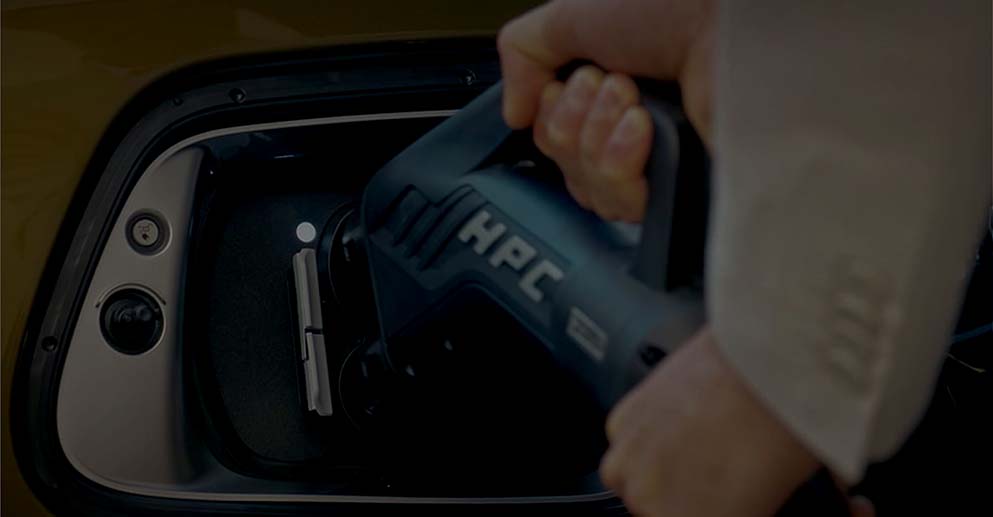 Person charging vehicle with public charging system