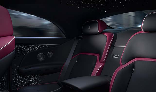 Luxurious rear seats of the Rolls-Royce Black Badge Spectre, featuring premium leather, bespoke detailing, and the Black Badge emblem.