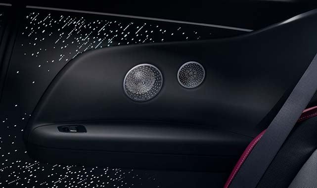Close-up of the Rolls-Royce Black Badge Spectre’s premium audio system, featuring high-fidelity rear speakers with bespoke grille design for an immersive sound experience.